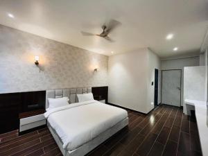 a bedroom with a large white bed and a desk at Hotel 777, Pushkar By Shivaneel Hospitality in Pushkar