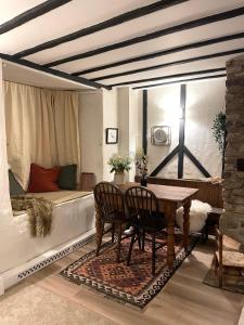 una sala da pranzo con tavolo e letto di Charming 2BR Cottage Retreat in the Centre of Bicester a Bicester