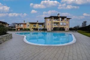 uma grande piscina em frente a uma grande casa em Maison Martina em Lonato