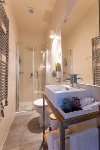 a bathroom with a sink and a toilet and a shower at Hotel San Giorgio in Vis