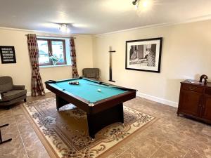 a living room with a pool table in it at Keepers Lodge with Hot Tub in Forgandenny