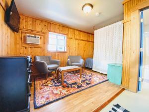 a living room with two chairs and a tv at Flathead Lake Resort in Bigfork