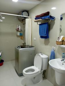 a bathroom with a toilet and a sink at Pham Gia Riverside Retreat in Hà Nam