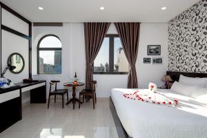 Postel nebo postele na pokoji v ubytování Dylan Hotel Danang