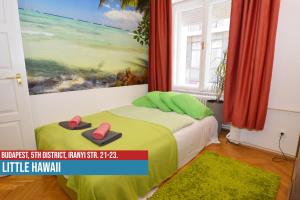 a bedroom with a bed with a painting on the wall at Little Americas Downtown Apartments in Budapest