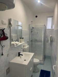 a bathroom with a sink and a toilet and a shower at Retreat Apartments with free parking in Pula +30 photos