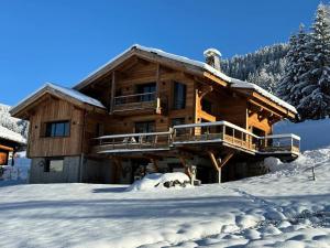 a log cabin in the snow with snow at Chalet - Chalets 101 in Notre-Dame-de-Bellecombe