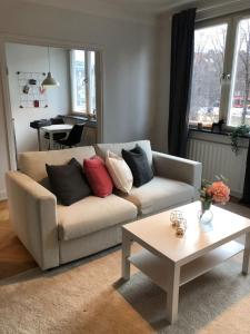 a living room with a couch and a table at Lovely Ostermalm apartment in Stockholm