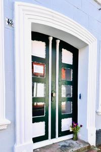 a front door of a house with a green door at Apartments am Wellenreiter in Tating