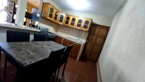 cocina con mesa, sillas y barra en Hostal Sweet Dreams en Panajachel