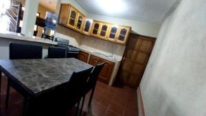 a kitchen with a table and chairs and a counter at Hostal Sweet Dreams in Panajachel