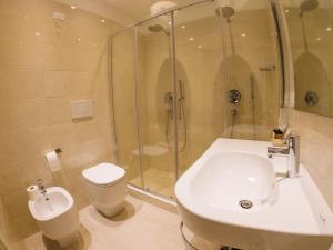 a bathroom with a shower and a sink and a toilet at Hotel Universal in Livorno