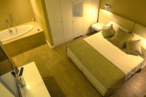 a small bathroom with a bed and a bath tub at Hotel Universal in Livorno