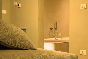 a bedroom with a sink and a bed with a pillow at Hotel Universal in Livorno