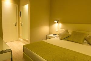 a hotel room with a bed and a bathroom at Hotel Universal in Livorno