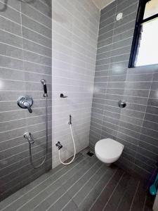 a bathroom with a toilet and a shower at Coast & Comfort Stays - 2 BHK home in Panjim in Panaji