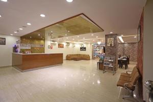 a lobby of a store with a counter and chairs at Hotel D'Capitol - Delhi Airport in New Delhi