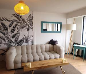 a living room with a couch and a table at La Vigie perchée - Les Gîtes de la Côte d'Amour in Le Croisic