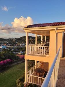 a balcony of a house with a table on it at Marina View Villa in Gros Islet