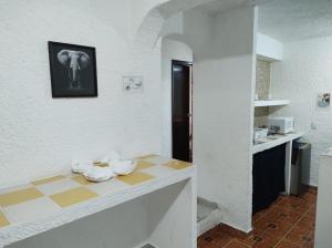 a room with a table with a picture of an elephant on the wall at Íkaro Suites Cancún in Cancún