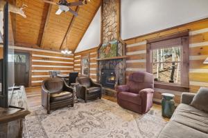a living room with chairs and a fireplace at New Listing Forest Footprints in Big Canoe in Afton