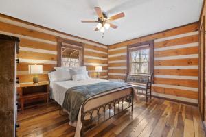 a bedroom with a bed and a ceiling fan at New Listing Forest Footprints in Big Canoe in Afton