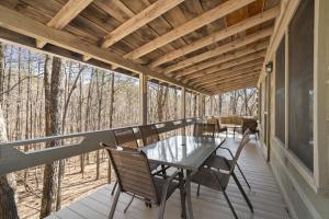 a screened porch with a glass table and chairs at New Listing Forest Footprints in Big Canoe in Afton