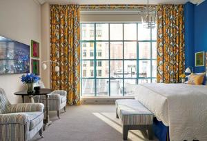 a bedroom with a bed and a large window at Warren Street Hotel in New York