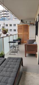 a balcony with a bench and a table on a building at Tranquilo y relajante Apartamento familiar in Esplugues de Llobregat