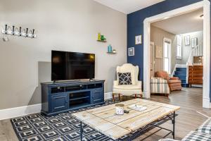 a living room with a tv and a table at Pet-Friendly Indianapolis Retreat Near City Center in Indianapolis