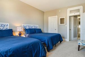 two beds in a room with blue sheets at Pet-Friendly Indianapolis Retreat Near City Center in Indianapolis
