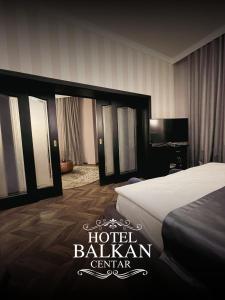 a hotel room with a bed and a television at Hotel Balkan Centar in Bijeljina