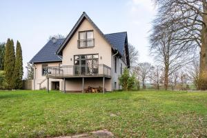 a large white house with a large yard at Buchenhof in Delingsdorf