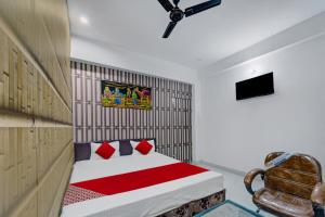 a bedroom with a bed and a chair in it at Flagship Hotel Blue Gram Inn in Patna