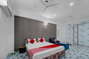 a bedroom with a bed and a ceiling fan at Flagship Hotel Blue Gram Inn in Patna