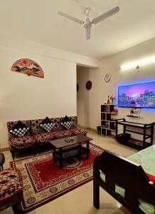 a living room with a couch and a table at Raga Homestay 2.0- Urban Comfort in Guwahati