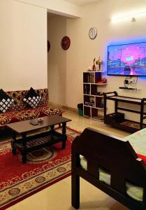 a living room with a couch and a table at Raga Homestay 2.0- Urban Comfort in Guwahati