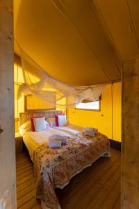 a bedroom with a large bed in a tent at Tenuta Delle Ripalte in Capoliveri