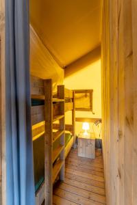 a room with two bunk beds and a lamp at Tenuta Delle Ripalte in Capoliveri