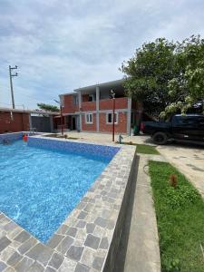 a large swimming pool in front of a building at Casa Polska in Paiján