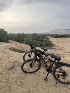 a bike parked on a dirt road in the desert at Casa Polska in Paiján