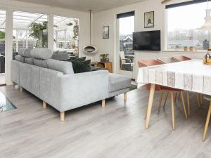 a living room with a couch and a table at 5 person holiday home in Juelsminde-By Traum in Sønderby