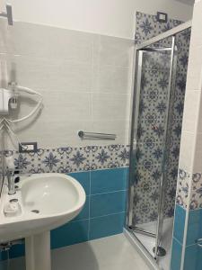 een badkamer met een wastafel en een douche bij Oriente Rooms in San Nicola Arcella