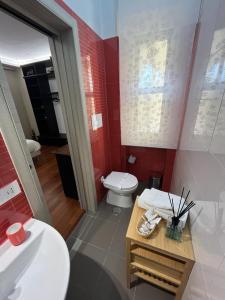 a bathroom with a toilet and a sink at L'Aurora B&B in Salerno