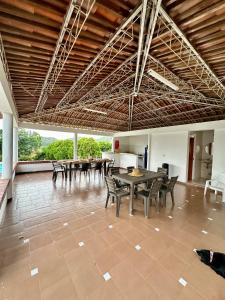 a large room with tables and chairs in it at Finca tres colinas in Lemos
