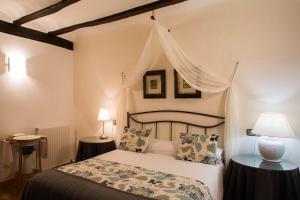 a bedroom with a bed with a canopy at Casa de la Cadena in Asiáin