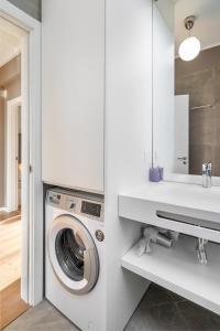 a white laundry room with a washing machine and a sink at WHome | 270º Panoramic View Premium Apartment in Lisbon
