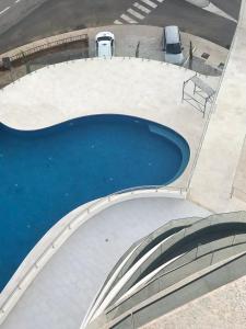 a large pool of blue water in a parking lot at Cozy Home in Bečići