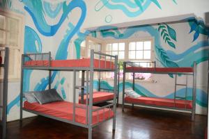 two bunk beds in a room with a mural at AKKUI HOSTEL in São Paulo
