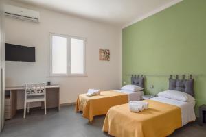 Ένα ή περισσότερα κρεβάτια σε δωμάτιο στο Casa Salvemini
